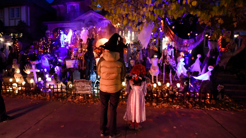 People go trick-or-treating at a decorated home in the Glebe neighbourhood in Ottawa on Halloween, Monday, Oct. 31, 2016 in Ottawa. (Justin Tang/THE CANADIAN PRESS)