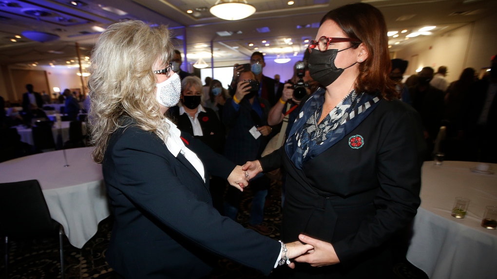 Manitoba's newly elected Progressive Conservative Leader and the province's new premier, Heather Stefanson, right, greets opponent Shelly Glover at a victory party after defeating her in a leadership race in Winnipeg, Saturday, October 30, 2021. THE CANADIAN PRESS/John Woods 