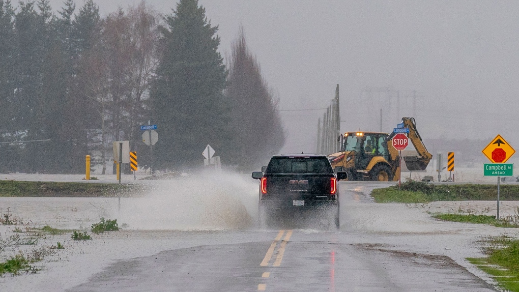 A truck drives along the flooded roads of Abbotsford, B.C., Thursday, November 25, 2021. THE CANADIAN PRESS/Jonathan Hayward 