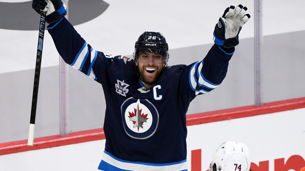 Winnipeg Jets' Blake Wheeler (26) celebrates a goal by Mark Scheifele during third period NHL Stanley Cup playoff action against the Edmonton Oilers, in Winnipeg on Monday, May 24, 2021. (THE CANADIAN PRESS/Fred Greenslade)