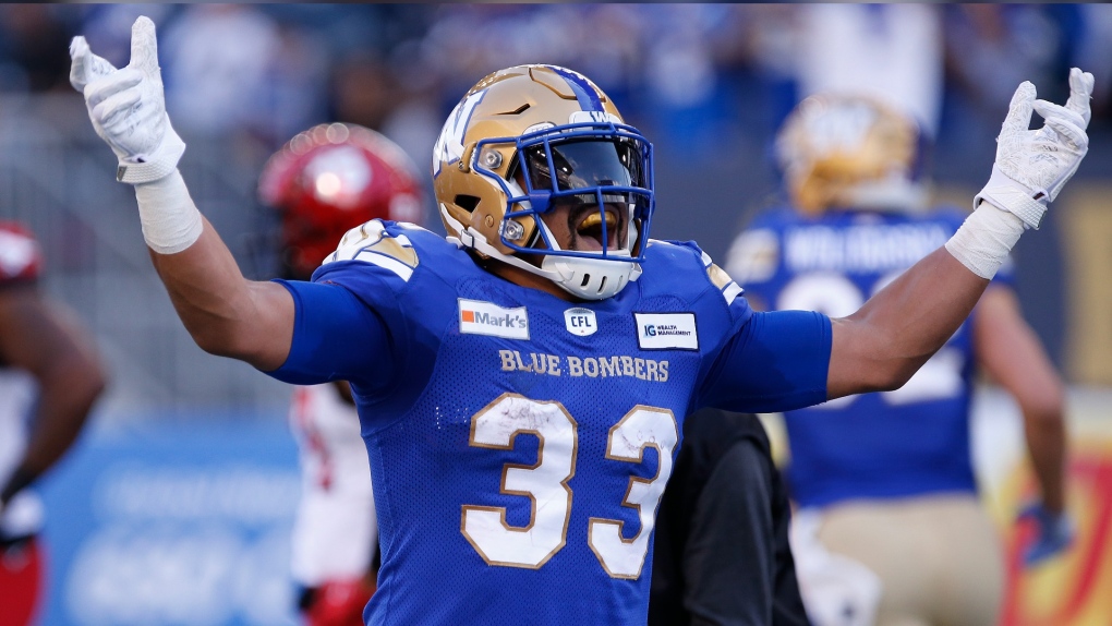 Winnipeg Blue Bombers' Andrew Harris (33) celebrates his touchdown against the Calgary Stampeders during first half CFL football action in Winnipeg, Sunday, Aug. 29, 2021. (THE CANADIAN PRESS/John Woods) 