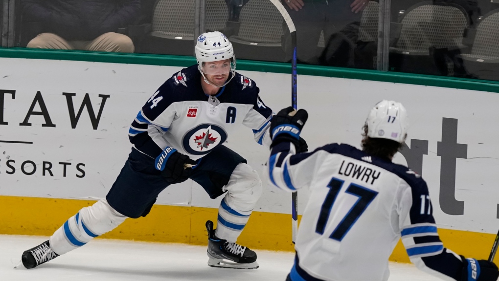 Winnipeg Jets' Josh Morrissey (44) celebrates scoring a goal with teammate Adam Lowry (17) during overtime in an NHL hockey game against the Dallas Stars in Dallas, Friday, Nov. 25, 2022. The Jets won 5-4. (AP Photo/LM Otero)