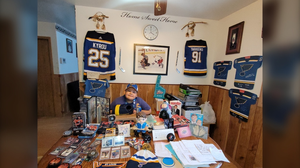 Wynston Martin, Manitoba boy with his new collection of hockey cards. 