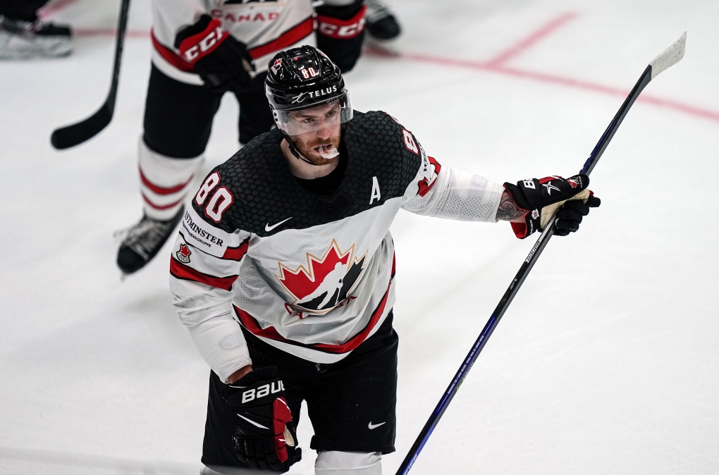 Pierre-Luc Dubois of Canada, in front, celebrates with his team after he scored his side's third goal during the group A Hockey World Championship match between Slovakia and Canada in Helsinki, Finland, Monday May 16, 2022. (AP Photo/Martin Meissner)