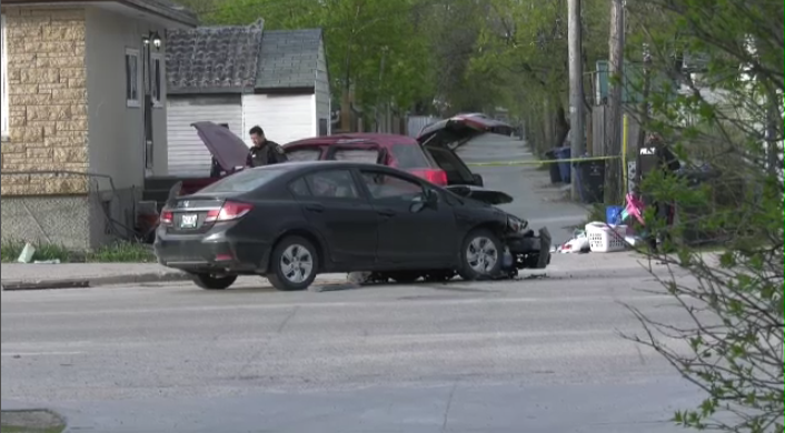 Officers with the Winnipeg Police Service on scene of the crash in the West End.