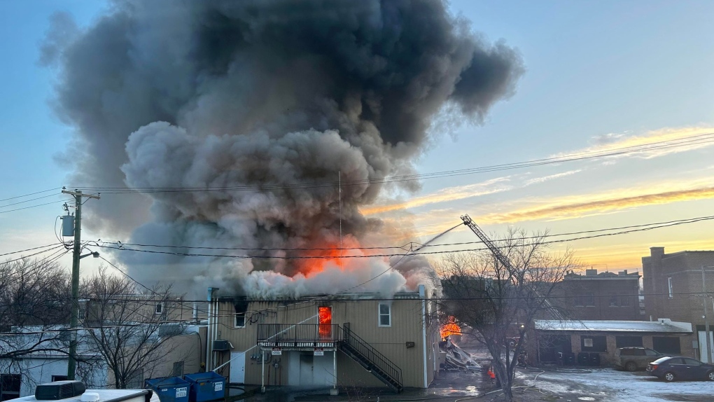 Flames can be seen shooting from a building on 12th Street in Brandon on Nov. 20, 2023. Brandon Police believe the cause of the fire to be arson and have arrested a 33-year-old man. (Submitted photo: Angel Tanner)