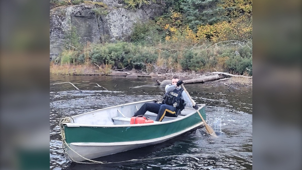 A RCMP officer paddles a boat to help rescue a hiker on the Mantario Trial on Sept. 18 (Image source: RCMP Manitoba)